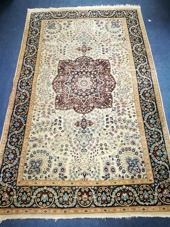 A Persian cream and blue ground rug 212cm x 137cm